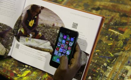 Cassandra Algy demonstrates using QR codes to hear audio of the Gurindji text in the Kawarla book. Cassandra Algy demonstrates using QR codes to hear audio of the Gurindji text in the Kawarla book.